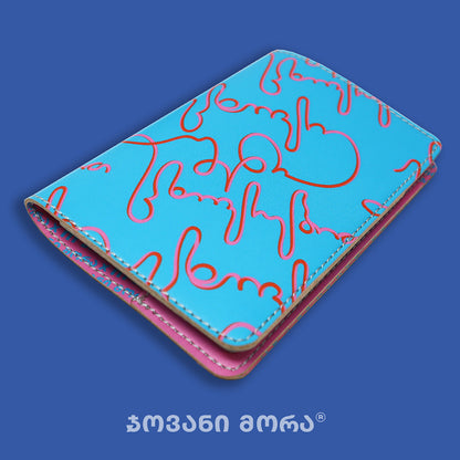 Folded light blue and pink vegan leather passport holder with Live Your Own Life print by Giovanni Morra