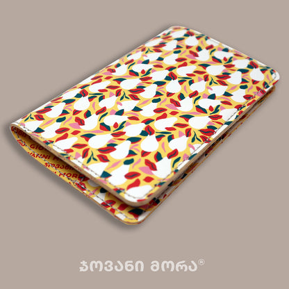 Folded yellow and white vegan leather passport holder with Pears print by Giovanni Morra